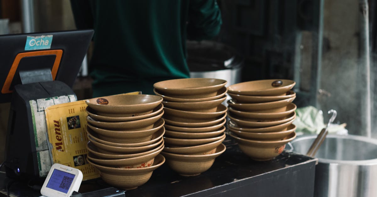 Stacked bowls at a street food stall in Hanoi, Vietnam, capturing local culinary atmosphere.